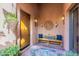 Inviting entryway featuring a wooden door, bench with pillows, and decorative wall accents at 7442 E Golden Eagle Cir, Gold Canyon, AZ 85118