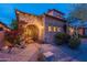 Stone entryway with wrought iron gate, lush landscaping, and bougainvillea at 7442 E Golden Eagle Cir, Gold Canyon, AZ 85118