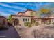 Charming two-story stucco home featuring a two-car garage and a tile roof on a sunny day at 7442 E Golden Eagle Cir, Gold Canyon, AZ 85118