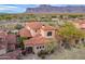 Aerial view of a red tile roof home with desert landscaping and a private gated courtyard at 7442 E Golden Eagle Cir, Gold Canyon, AZ 85118