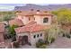 Elegant Southwestern-style home with a red tile roof and mountain views at 7442 E Golden Eagle Cir, Gold Canyon, AZ 85118