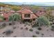 Aerial view of a home featuring a red tile roof, desert landscaping, and a second story balcony at 7442 E Golden Eagle Cir, Gold Canyon, AZ 85118