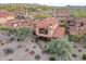 Aerial view of a red tile roof home with desert landscaping and a second story balcony at 7442 E Golden Eagle Cir, Gold Canyon, AZ 85118