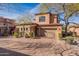 Charming two-story stucco home featuring a two-car garage and a tile roof on a sunny day at 7442 E Golden Eagle Cir, Gold Canyon, AZ 85118