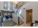 Spacious foyer featuring a staircase, chandelier, and elegant tile flooring at 7442 E Golden Eagle Cir, Gold Canyon, AZ 85118