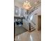 Grand foyer with a staircase, chandelier, and views into the living area at 7442 E Golden Eagle Cir, Gold Canyon, AZ 85118