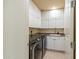 Well-lit laundry room featuring matching washer and dryer plus white cabinets and sink at 7442 E Golden Eagle Cir, Gold Canyon, AZ 85118