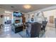 Elegant living room features a stone fireplace, large TV, and comfortable leather seating, perfect for relaxation at 7442 E Golden Eagle Cir, Gold Canyon, AZ 85118