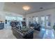 Open-concept living room flows into kitchen with leather seating and natural light from large windows at 7442 E Golden Eagle Cir, Gold Canyon, AZ 85118