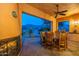 Covered patio area with a full dining set, mountain views and a fireplace at 7442 E Golden Eagle Cir, Gold Canyon, AZ 85118