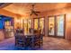 Covered patio area with ceiling fan, an outdoor kitchen and a dining table set at 7442 E Golden Eagle Cir, Gold Canyon, AZ 85118