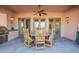 Covered patio featuring a round dining table with chairs, tile flooring, and a built in BBQ at 7442 E Golden Eagle Cir, Gold Canyon, AZ 85118