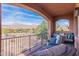 Inviting covered patio features comfortable seating and stunning views of golf course and mountains at 7442 E Golden Eagle Cir, Gold Canyon, AZ 85118