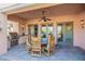 A covered patio with a dining table, chairs, an outdoor fan, and a built-in grill at 7442 E Golden Eagle Cir, Gold Canyon, AZ 85118