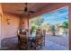 Covered patio includes a dining table and chairs and offers views of desert landscaping at 7442 E Golden Eagle Cir, Gold Canyon, AZ 85118