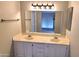 Bathroom featuring a double sink vanity with framed mirror and a neutral color scheme at 9445 N 94Th Pl # 201, Scottsdale, AZ 85258