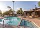 Inviting community pool with lounge chairs, palm trees, and a spa for relaxation and recreation at 9445 N 94Th Pl # 201, Scottsdale, AZ 85258