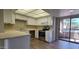 Bright kitchen featuring white cabinetry, stainless steel appliances and a sliding glass door to balcony at 9445 N 94Th Pl # 201, Scottsdale, AZ 85258