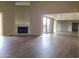 Spacious living room features a fireplace, wood flooring, and sliding glass doors leading to a patio at 9445 N 94Th Pl # 201, Scottsdale, AZ 85258