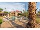 Relaxing poolside view featuring an umbrella table, lounge chairs, and community amenities at 9445 N 94Th Pl # 201, Scottsdale, AZ 85258