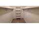 Spacious walk-in closet with built-in shelving and modern flooring at 9445 N 94Th Pl # 201, Scottsdale, AZ 85258