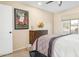 A simple bedroom with a ceiling fan and view out the window at 9501 W Hidden Valley Cir, Sun City, AZ 85351