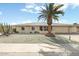 Charming single story home with well maintained desert landscaping and mature palm tree at 9501 W Hidden Valley Cir, Sun City, AZ 85351