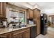 An updated kitchen featuring granite countertops, stainless steel appliances, and a window overlooking the backyard at 9501 W Hidden Valley Cir, Sun City, AZ 85351