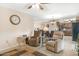 Open concept living room with two chairs, ceiling fan, and access to kitchen and dining areas at 9501 W Hidden Valley Cir, Sun City, AZ 85351