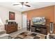 Cozy living room with a ceiling fan and television at 9501 W Hidden Valley Cir, Sun City, AZ 85351