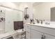 Bright bathroom featuring a glass-enclosed shower and a modern vanity with ample counter space at 9509 W Illini St, Tolleson, AZ 85353