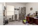 Bedroom featuring many stacked boxes and a dark wooden desk under a window at 9509 W Illini St, Tolleson, AZ 85353