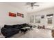 Cozy living room with plush carpet, ceiling fan, and sliding doors for easy access at 9509 W Illini St, Tolleson, AZ 85353