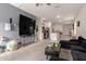 Open-concept living room seamlessly connects to the modern kitchen, creating a functional living space at 9509 W Illini St, Tolleson, AZ 85353