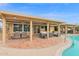 Covered back patio with dining, lounge area, and access to the pool at 9517 W Cedar Hill Cir # N, Sun City, AZ 85351