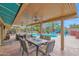 Covered patio area with outdoor dining, seating, pool, and waterslide at 9517 W Cedar Hill Cir # N, Sun City, AZ 85351