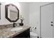 Bright bathroom featuring granite counters, decorative mirror, and modern fixtures at 9517 W Cedar Hill Cir # N, Sun City, AZ 85351