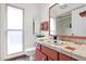 Bright bathroom with custom tile work, ample counter space and natural light from the window at 9517 W Cedar Hill Cir # N, Sun City, AZ 85351