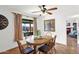 Charming dining room with wood table, chairs, ceiling fan, and view of the pool at 9517 W Cedar Hill Cir # N, Sun City, AZ 85351