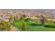 Scenic view of community golf course featuring green grass and mature trees at 9517 W Cedar Hill Cir # N, Sun City, AZ 85351