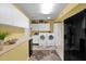 Well-lit laundry room featuring modern washer and dryer units and plenty of storage at 9517 W Cedar Hill Cir # N, Sun City, AZ 85351