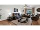 Comfortable living room with leather furniture, a decorative rug, and a ceiling fan at 9517 W Cedar Hill Cir # N, Sun City, AZ 85351