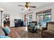 Bright recreation room with recliners and view of the backyard pool through large windows at 9517 W Cedar Hill Cir # N, Sun City, AZ 85351