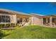 This backyard features a lush lawn and covered patios perfect for outdoor relaxation and entertaining at 9617 E Holiday Way, Sun Lakes, AZ 85248