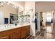 Bathroom with double sink vanity, large mirror, decor shelving, and glass-enclosed shower at 9617 E Holiday Way, Sun Lakes, AZ 85248