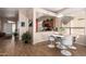 Stylish dining area with modern chairs and a view into kitchen at 9617 E Holiday Way, Sun Lakes, AZ 85248