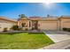 Charming single-story home with a well-manicured front yard and desert landscaping at 9617 E Holiday Way, Sun Lakes, AZ 85248