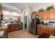 Well-lit kitchen with wood cabinets, stainless steel appliances, granite countertops, and wood-look tile flooring at 9617 E Holiday Way, Sun Lakes, AZ 85248