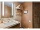 Well-lit bathroom featuring a stone countertop, stacked towels and decorative 'Thinking of You' art at 9962 E Groundcherry Ln, Scottsdale, AZ 85262