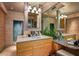 Elegant bathroom with granite countertops, dual sinks, and stylish modern lighting at 9962 E Groundcherry Ln, Scottsdale, AZ 85262